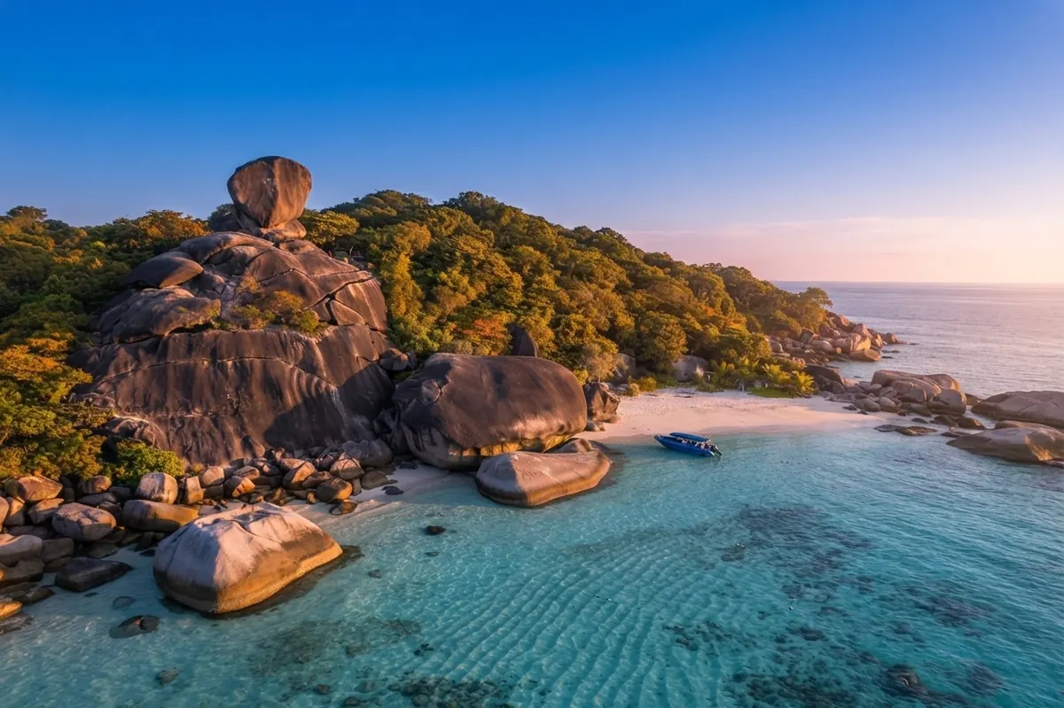Aerial view of Sail Rock and the granite headland of Koh Similan over clear shallow water
