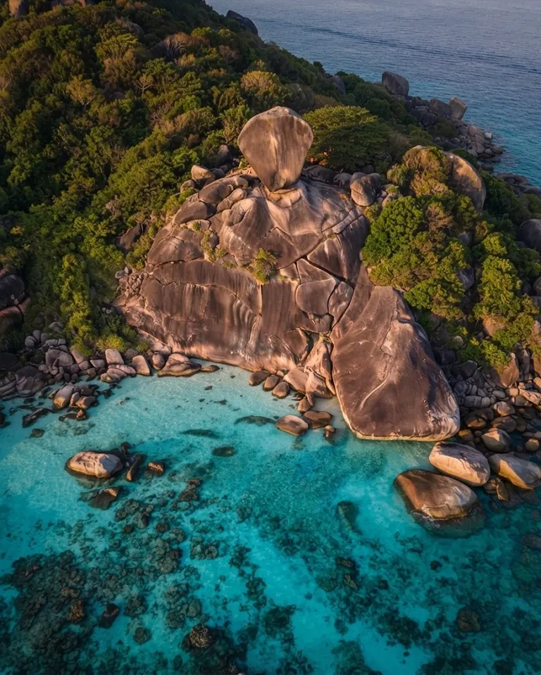 Aerial view straight down on Sail Rock, granite boulders and turquoise reef
