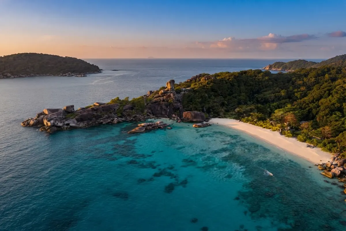 Aerial view of a sandy spit and forested island at sunset