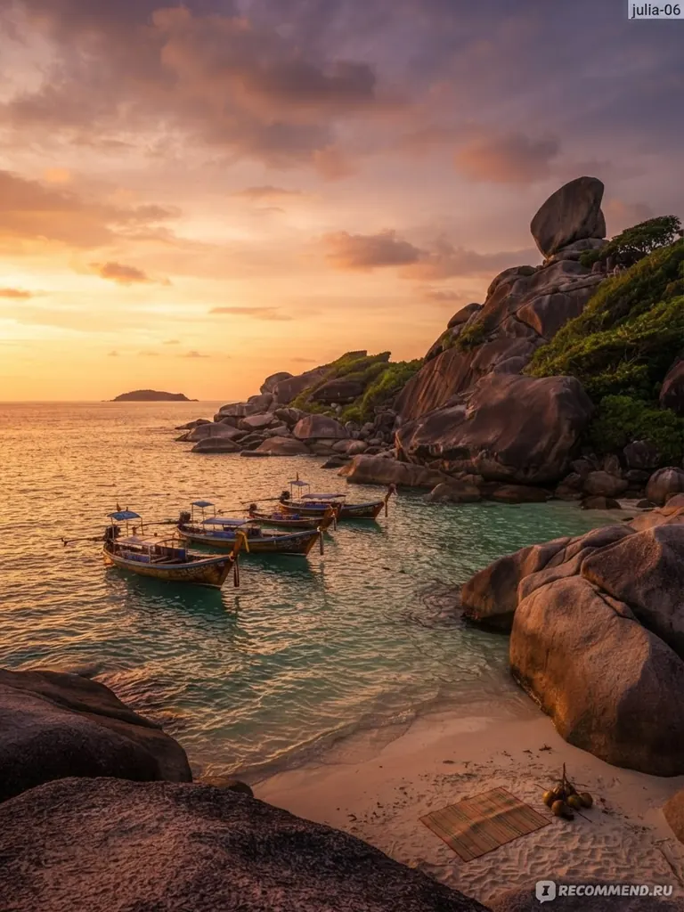 Longtail boats moored below Sail Rock at sunset